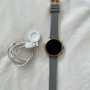 Fossil (gen 2?) smart watch with gray wristband and charger